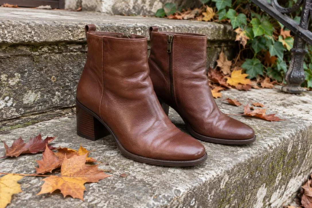Brown block-heel boots on a stone step